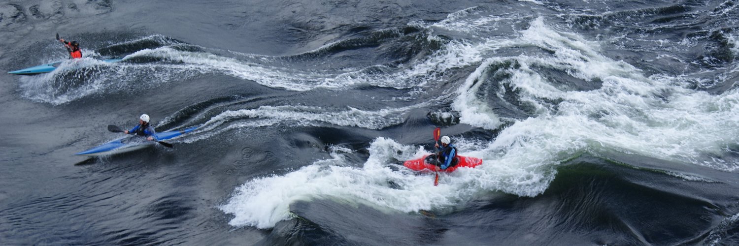 Kayakers riding the ebb at the Falls of Lora